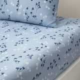 Celest blue duvet cover and pillow case with a scattered pattern of dark blue and white stylized plant motifs.