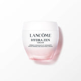Lancome Hydra Zen cream jar with a white lid and a clear glass body that transitions to light pink at the bottom. Black text.