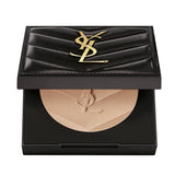 Open black YSL compact powder with a quilted lid and gold-toned YSL logo. The light beige powder is embossed with a YSL logo