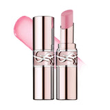 Two rose gold-toned lip balm tubes with silver-toned YSL logos. One open, revealing light pink glossy balm. A pink swatch is