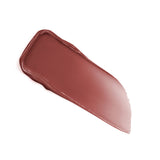A glossy swatch of muted reddish-brown lip product with slightly raised edges, tapering to a thinner end.