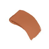 A swatch of terracotta-colored stick foundation with a creamy, textured finish.