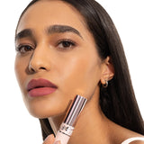 Light pink balm tube with a silver-toned YSL logo band and a shiny rose gold-toned metallic cap.