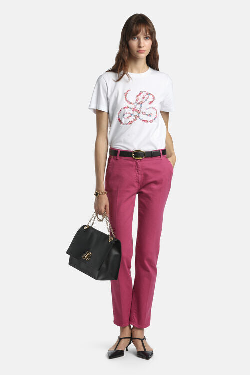 Off-white short-sleeve t-shirt with a round neck and a large 'L' initial on the front, made of pink and blue floral patterns.