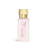 Clear rectangular glass perfume bottle with a light pink label and a gold-toned cap.