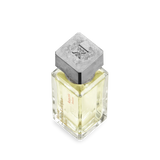 Clear square perfume bottle with pale yellow liquid, a textured matte silver-toned cap with an "FK" logo, and "Amyris homme"