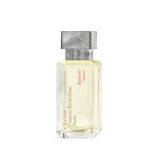 Clear rectangular perfume bottle with pale yellow liquid, gold-toned and red text, and a textured silver-toned cap.
