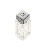Clear rectangular glass perfume bottle with a silver-toned square cap featuring an embossed FK logo. Brand text on side.