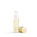 Clear glass roll-on elixir bottle with light yellow liquid, gold-toned text, and a separate gold-toned cylindrical cap.