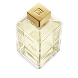 Square clear glass perfume bottle with pale yellow liquid, a gold-toned square cap with an embossed logo, and black and red t