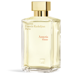 Clear glass perfume bottle with pale yellow liquid, a gold-toned rectangular cap, and gold-toned and reddish-orange text.