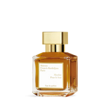 Rectangular glass perfume bottle with amber liquid, a gold-toned rectangular cap, and a white label on the front.