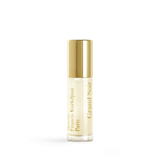 Clear glass roll-on perfume bottle with pale yellow liquid, a shiny gold-toned cap, and vertical gold text.
