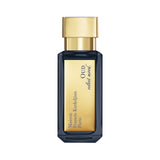 Dark blue rectangular perfume bottle with a gold-toned cap and a gold label featuring 'Maison Francis Kurkdjian Paris OUD vel