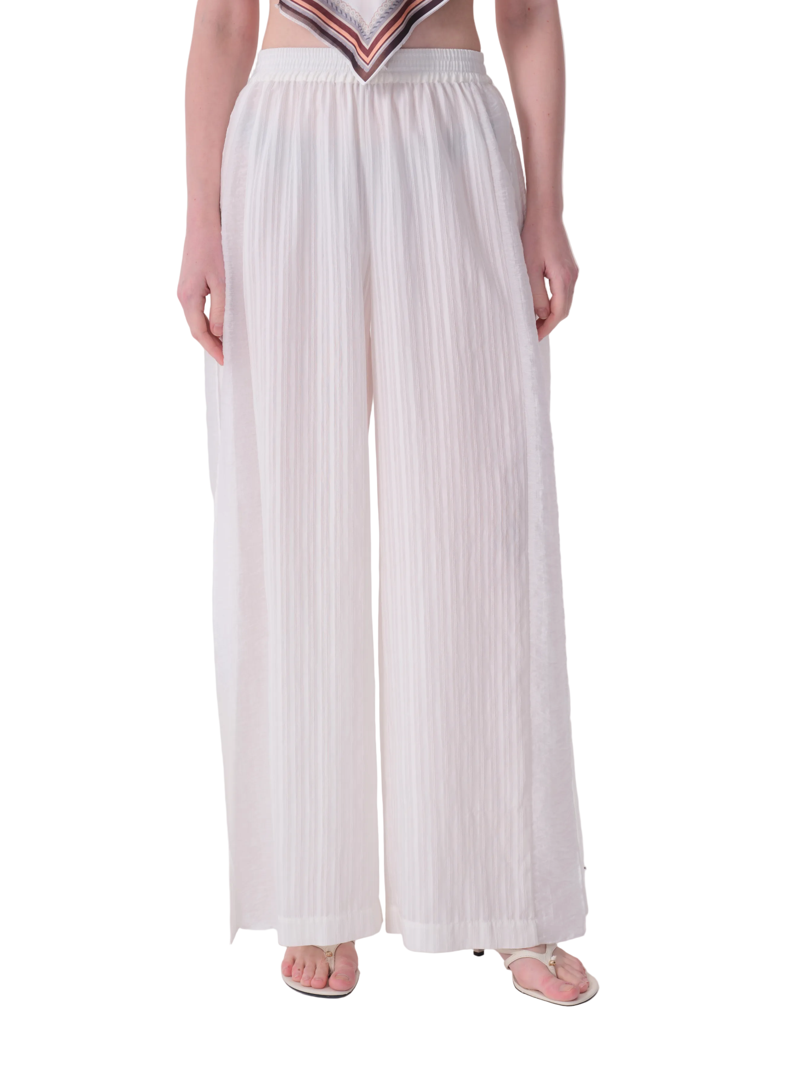 White wide-leg trousers with an elasticated waist and fine vertical pleats.