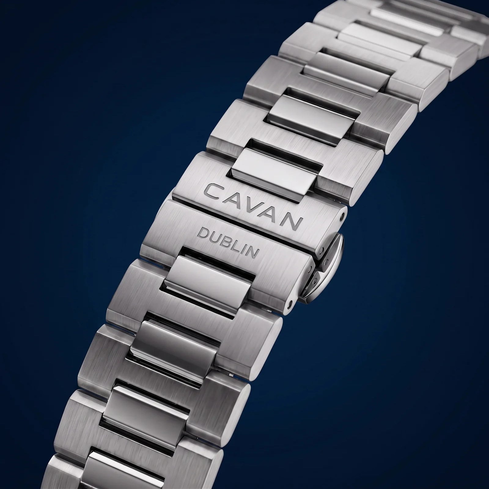 Silver-toned metal watch band with brushed and polished links. The clasp is engraved with 'CAVAN' and 'DUBLIN'.