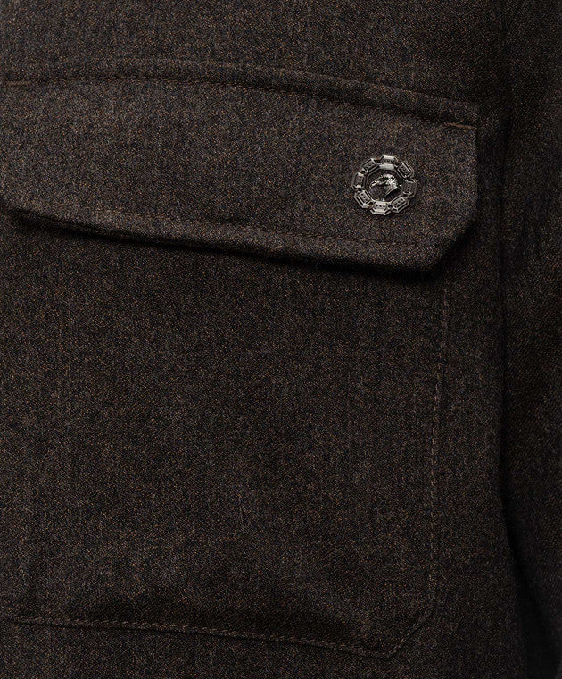 Brown sport jacket with textured fabric. A chest flap pocket is secured by a round, silver-toned button with a horse head mot