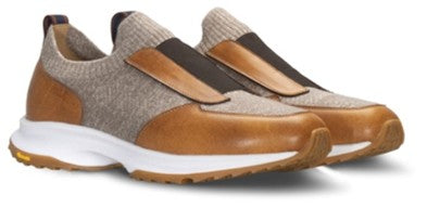 Pair of slip-on sneakers with light brown knit uppers, tan leather panels, dark brown elastic straps, white midsoles, and bro