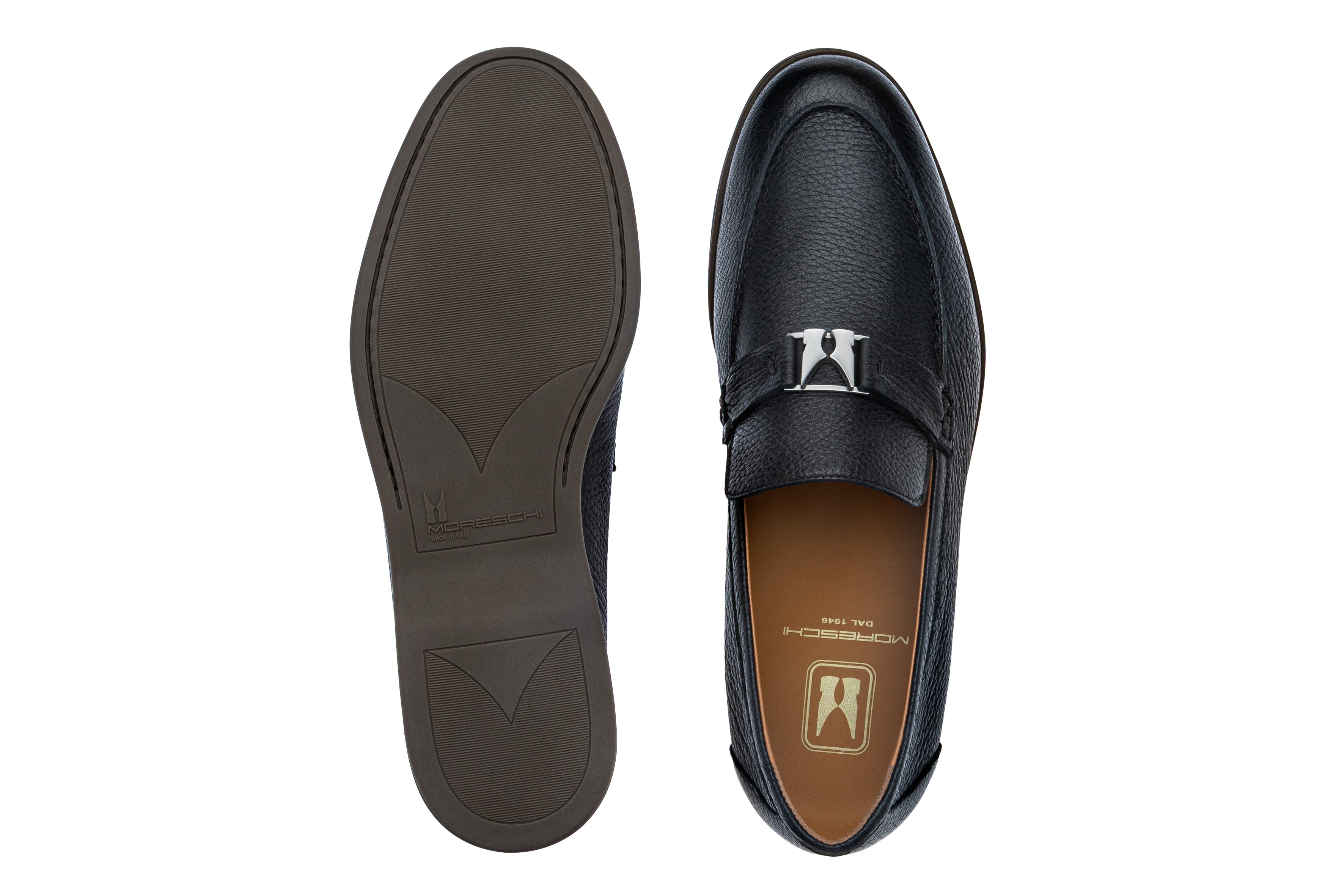 Navy blue pebbled leather loafer with a silver-toned buckle on the vamp strap and a dark brown textured sole.