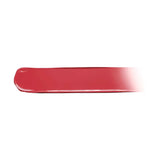 Swatch of YSL Candy Glaze showing a glossy, opaque coral-red cosmetic product with a rounded end and a faded edge.