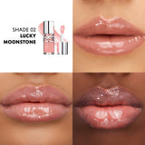 Clear lip gloss tube with silver-toned cap and YSL logo, containing light peachy-pink gloss with a matching doe-foot applicat