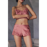 Dusty rose satin camisole and shorts set. Camisole has floral lace and sequin trim at neckline. Shorts have matching trim.