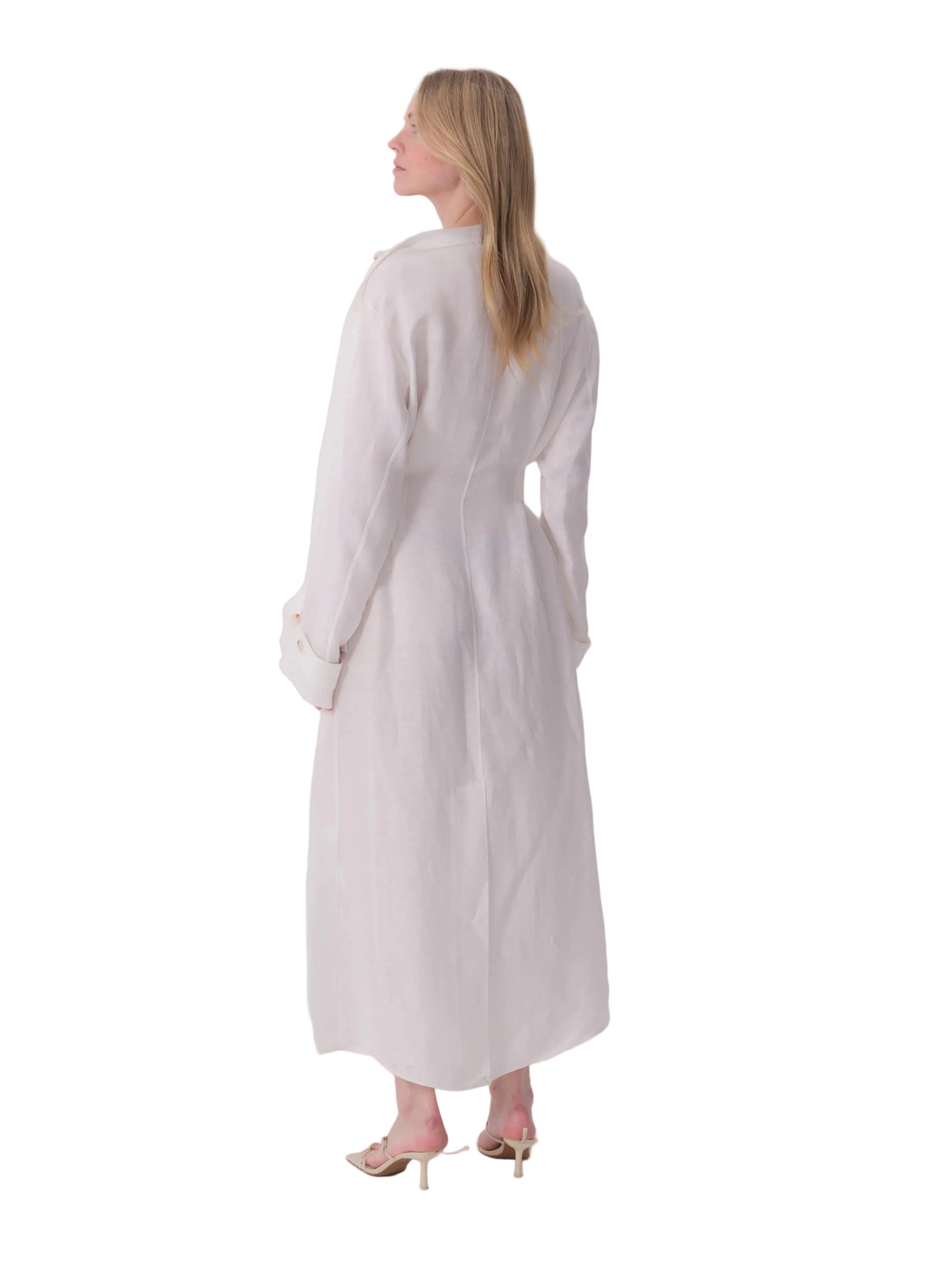 White linen-look dress with long cuffed sleeves, a band collar, and tailored back seams.