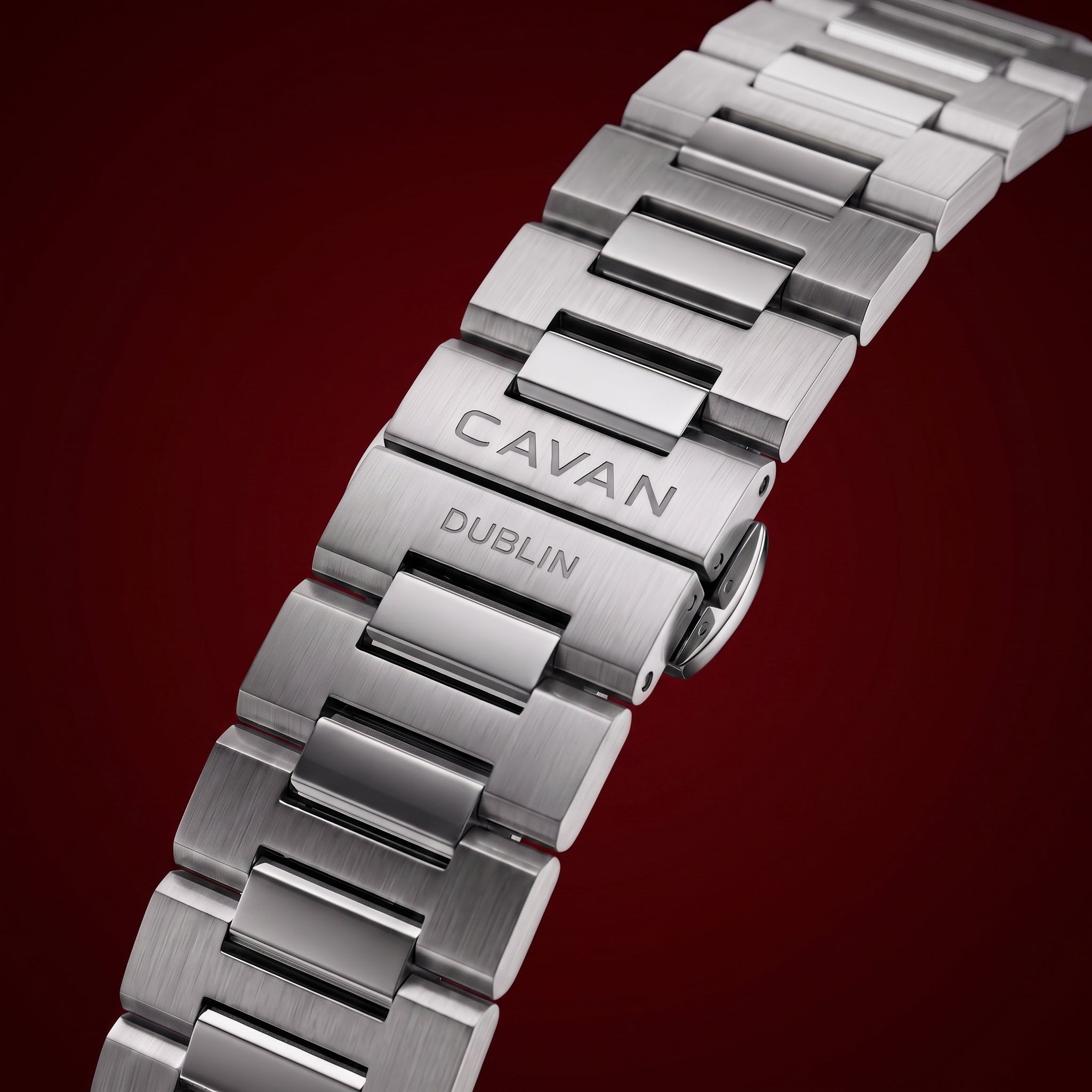 Silver-toned metal watch band with brushed and polished links. The deployant clasp is engraved with "CAVAN DUBLIN".