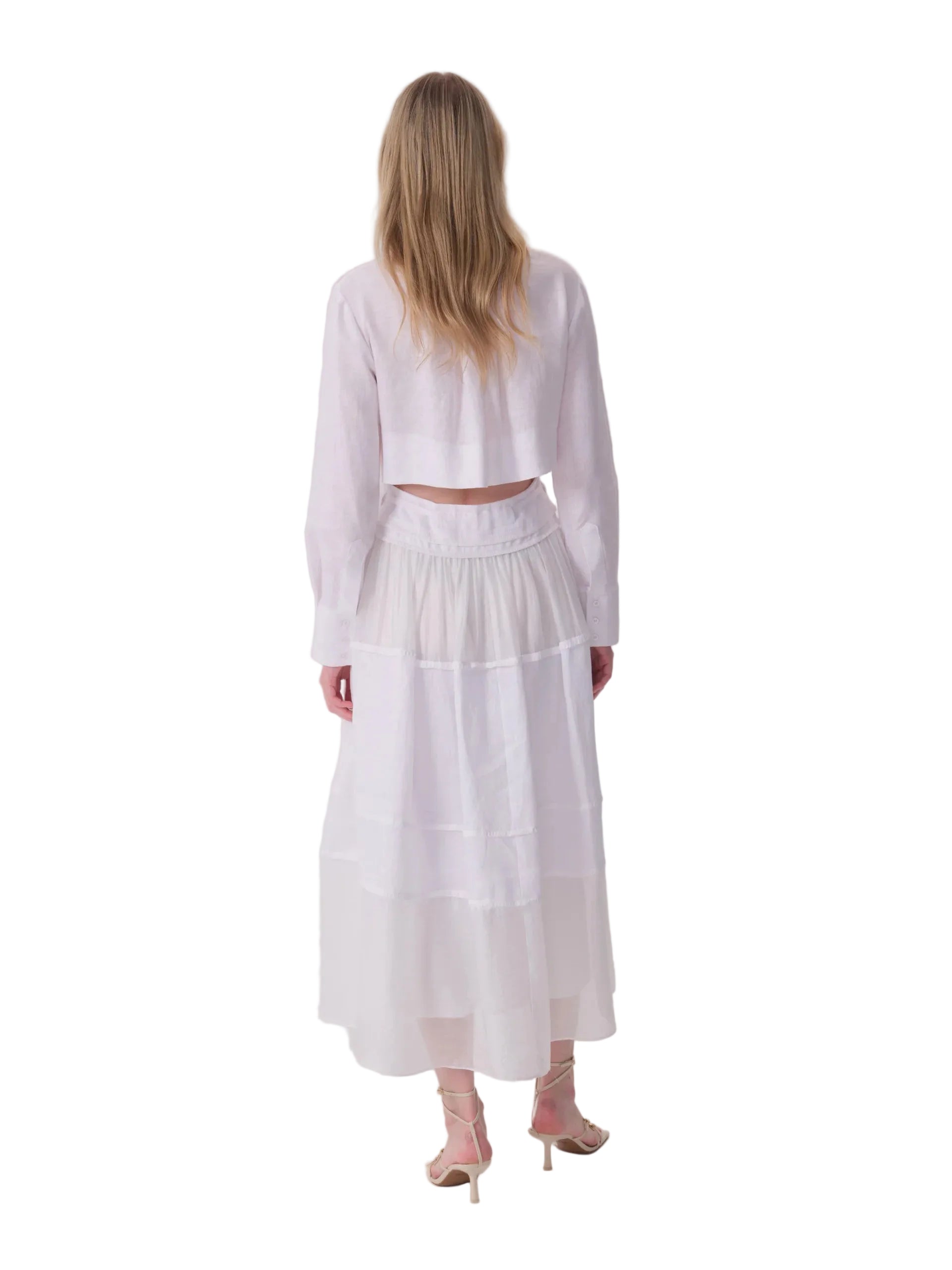 White long-sleeved dress with a cropped top and a long, tiered, sheer skirt.
