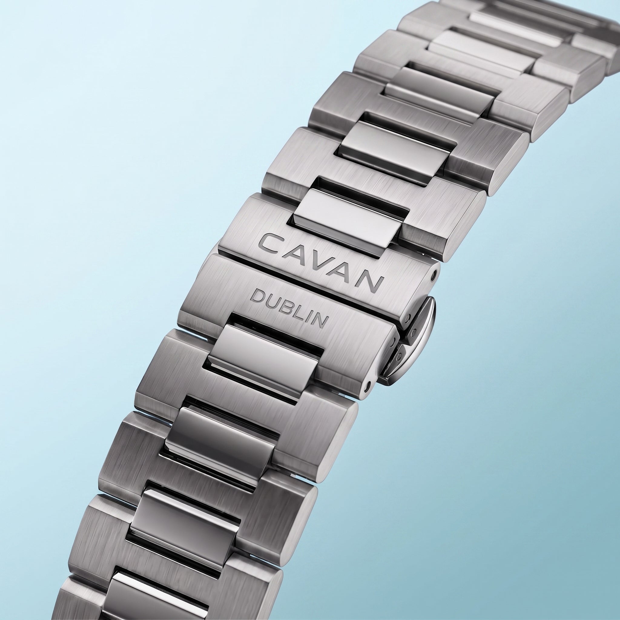 Silver-toned metal watch band with brushed outer links and polished inner links. The clasp is engraved with 'CAVAN' and 'DUBL