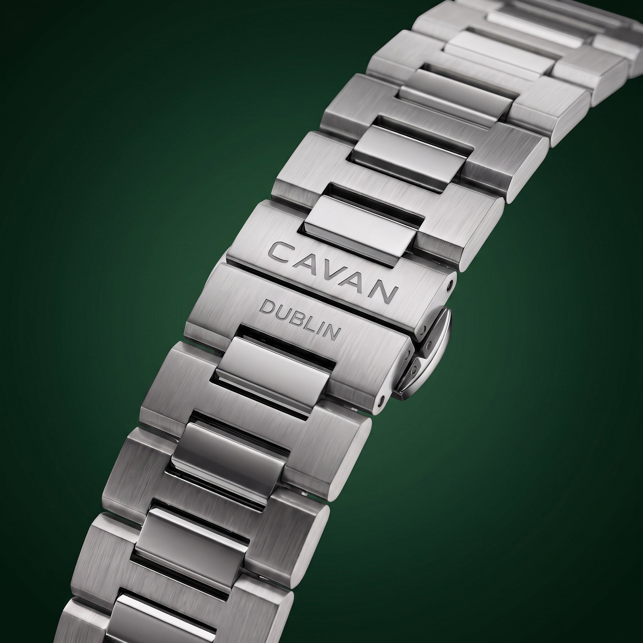 Silver-toned metal watch band with brushed and polished links, featuring an engraved clasp with 'CAVAN' and 'DUBLIN'.