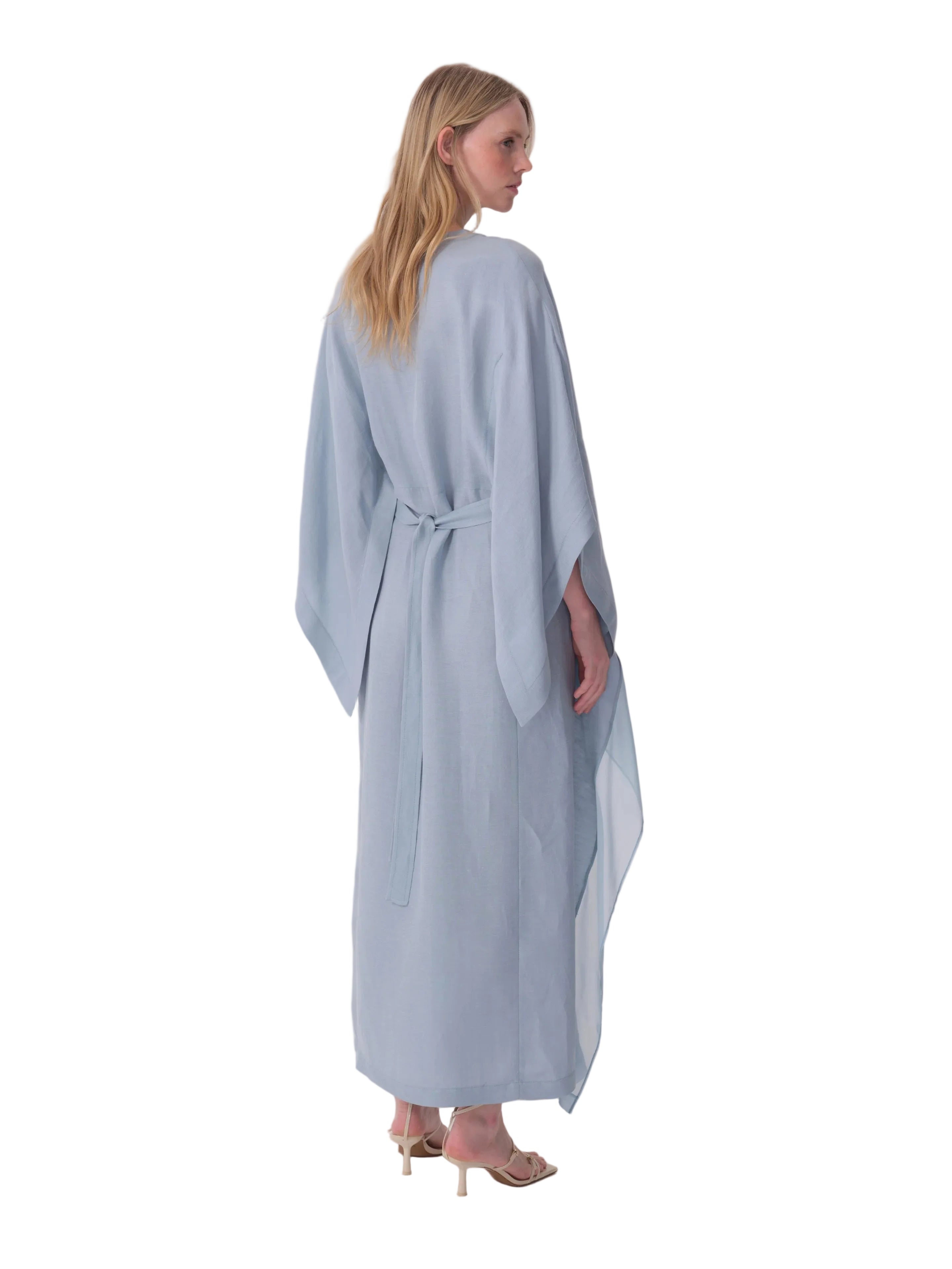 Light blue flowing maxi dress with wide kimono sleeves and a self-tie belt cinching the back waist.