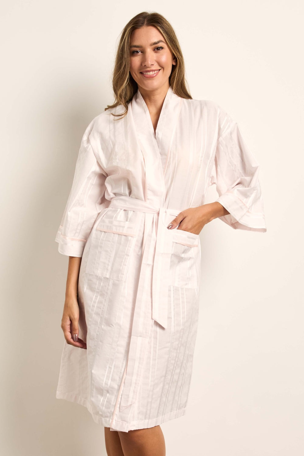 Pale pink sateen stripe kimono wrapover with 3/4 sleeves, self-tie belt, and two front patch pockets with pink trim.