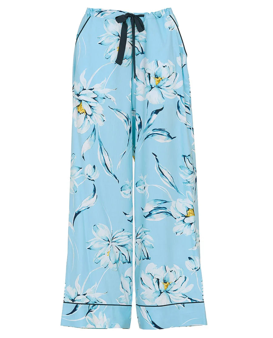 Light blue woven wide-leg trousers with white, blue, and yellow floral print, dark blue drawstring waist, and dark blue pipin