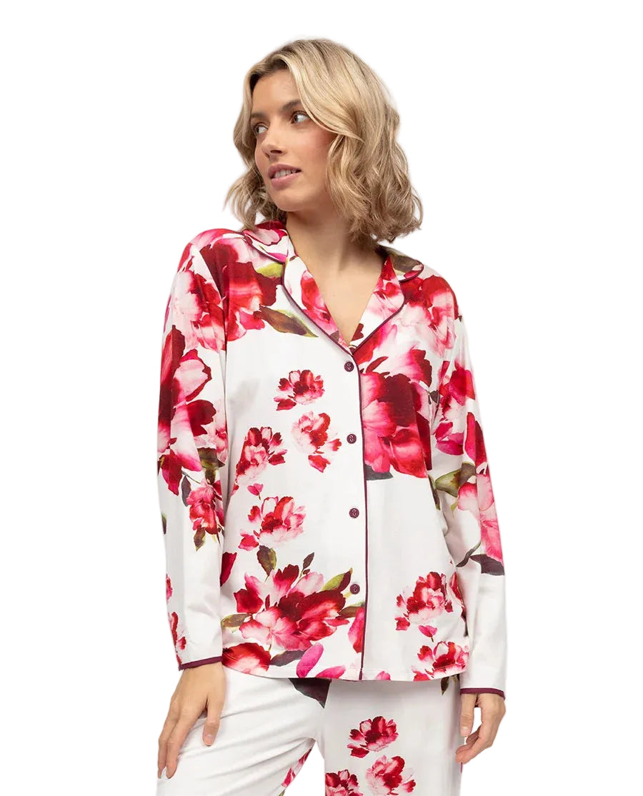White jersey long sleeve pyjama top with a red and pink floral print, ox blood piping, and matching buttons.