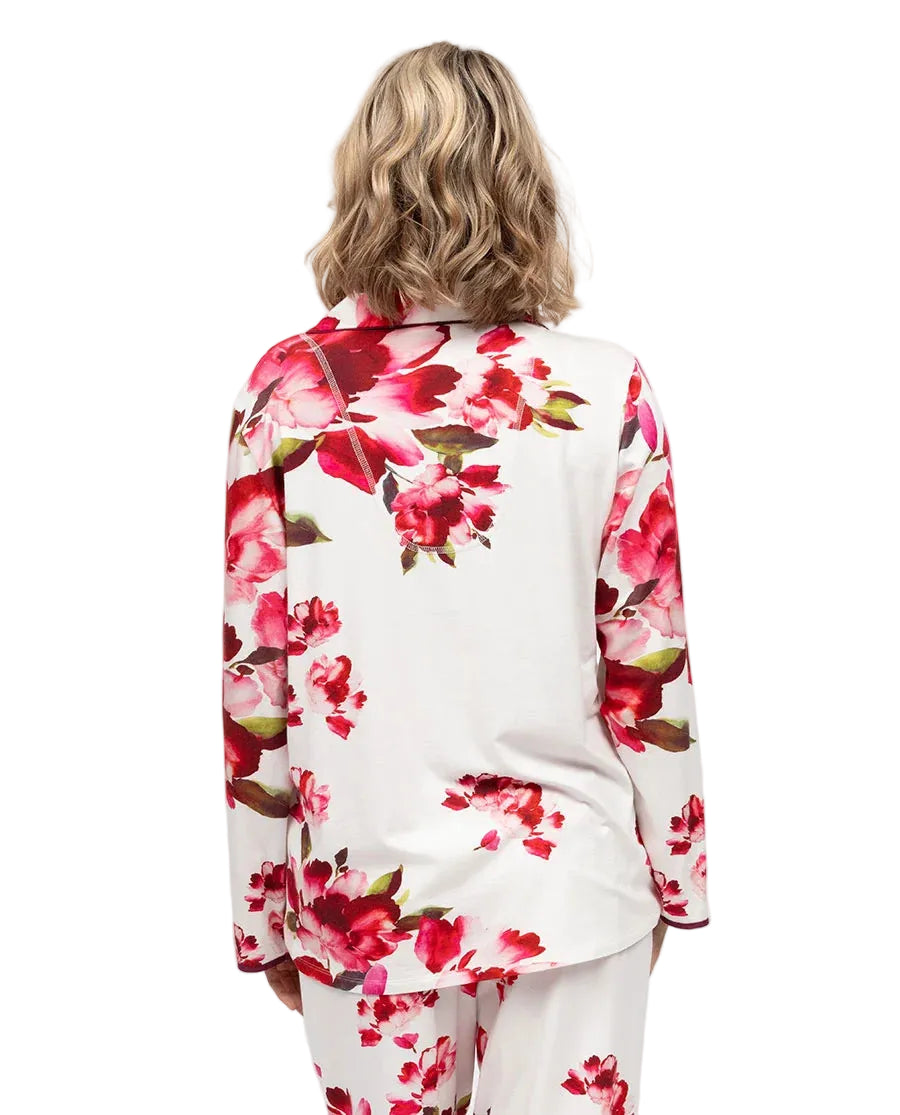White long-sleeved jersey pyjama top with red and pink floral print, dark piping on collar and cuffs, seen from the back.