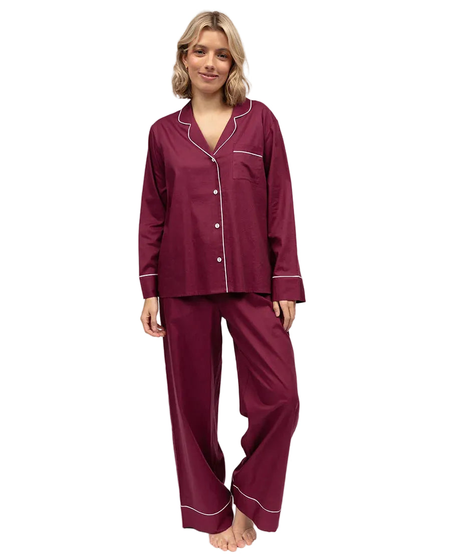 Ox blood long-sleeved pyjama top with white piping, notched lapel, and white buttons, paired with matching long pyjama trouse