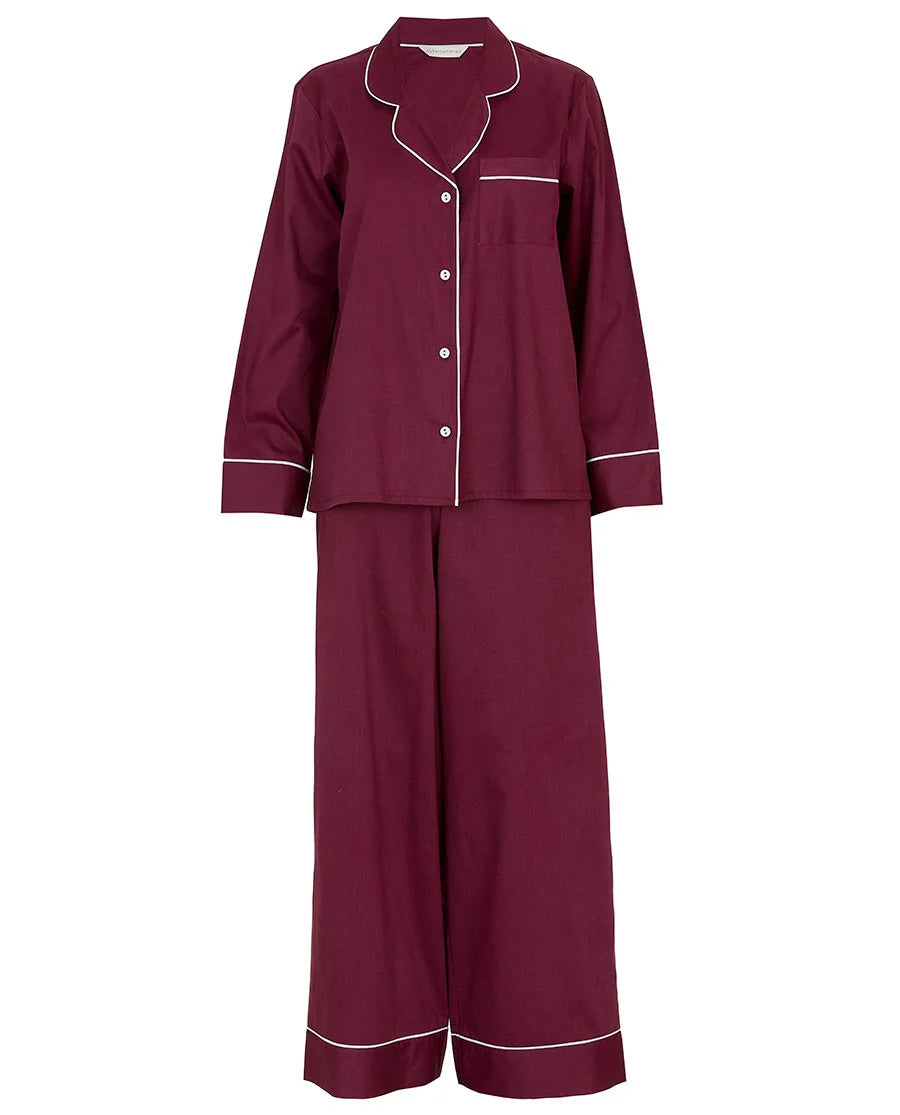 Ox blood long-sleeved pajama set with white piping on the collar, cuffs, chest pocket, and pant hems. Features white buttons.