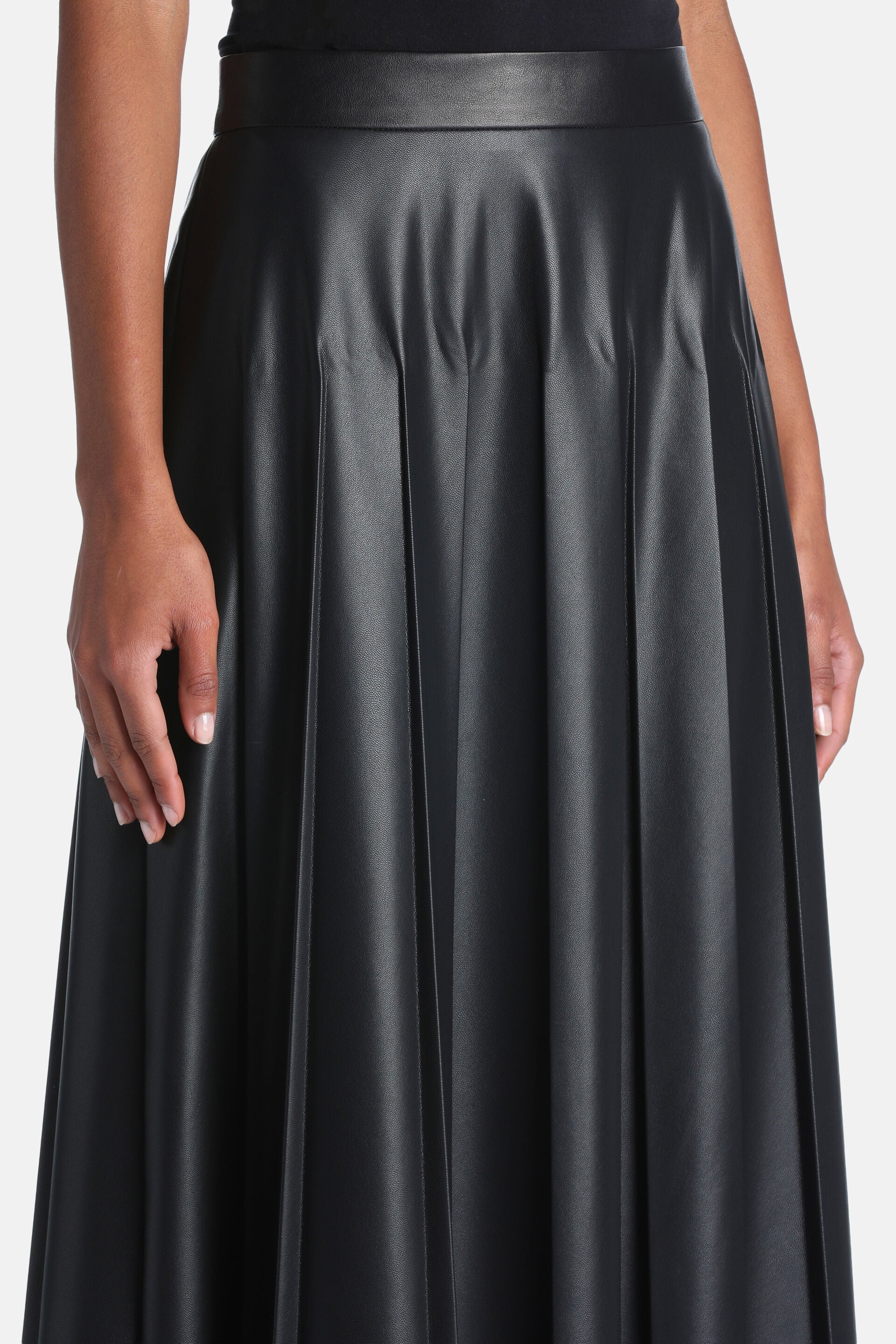 Black faux leather pleated skirt with a wide waistband.
