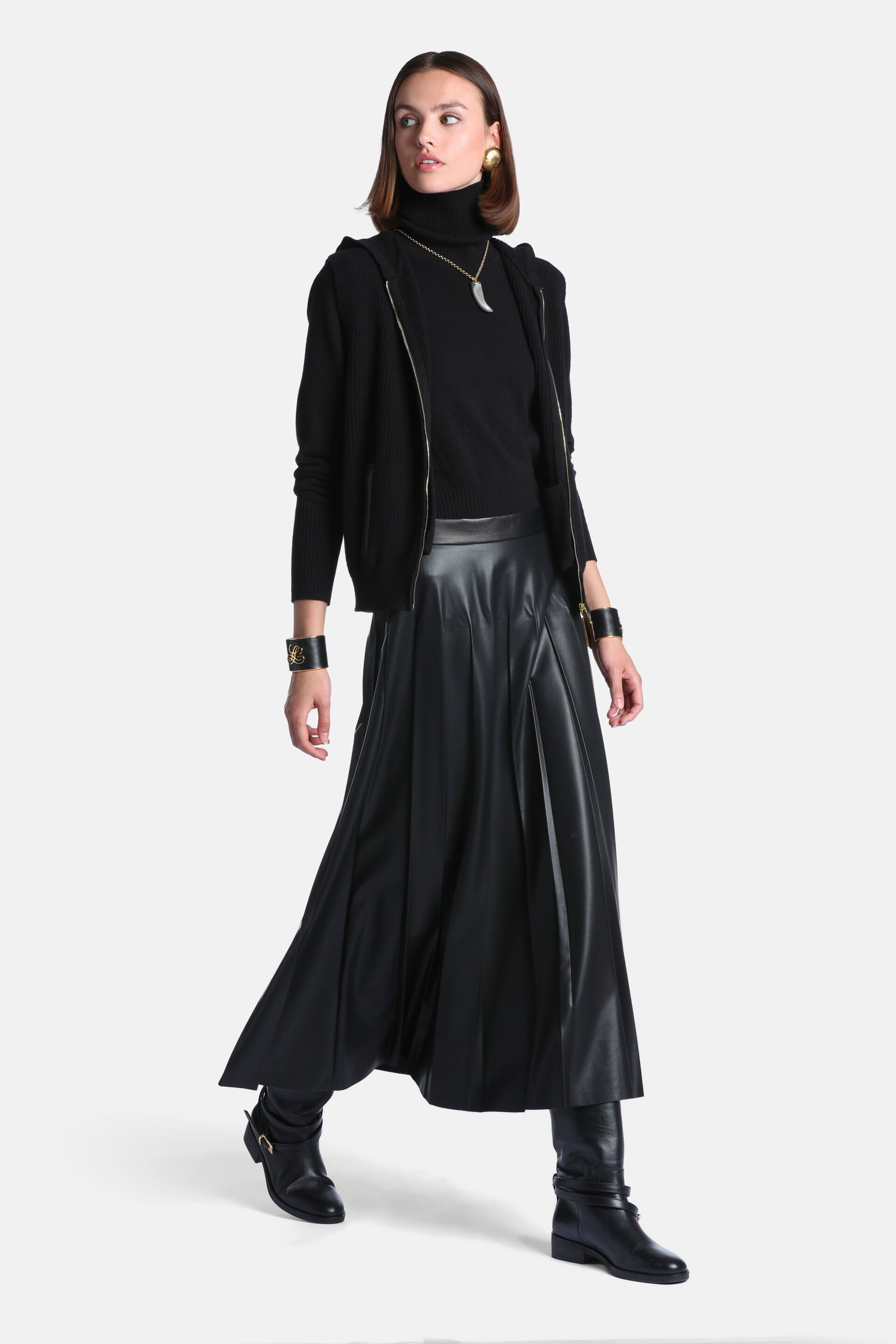Black faux leather maxi skirt with a wide waistband and vertical paneled design, flaring towards the hem.