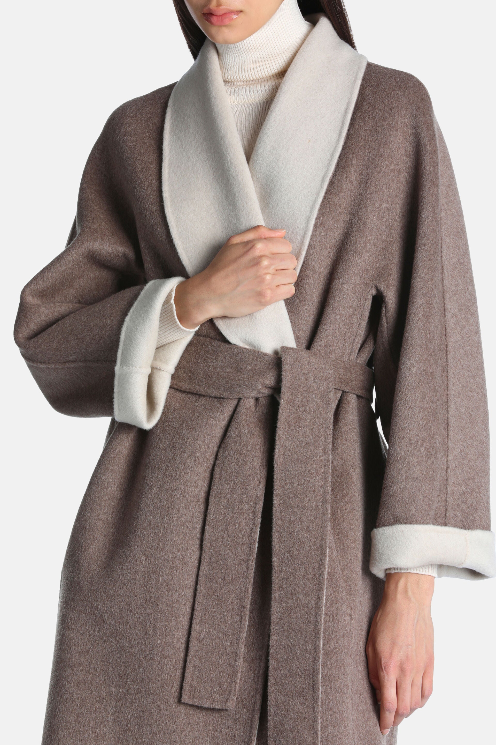 Dove grey wrap coat with wide cream shawl lapels, cream rolled cuffs, and a self-fabric tie belt.