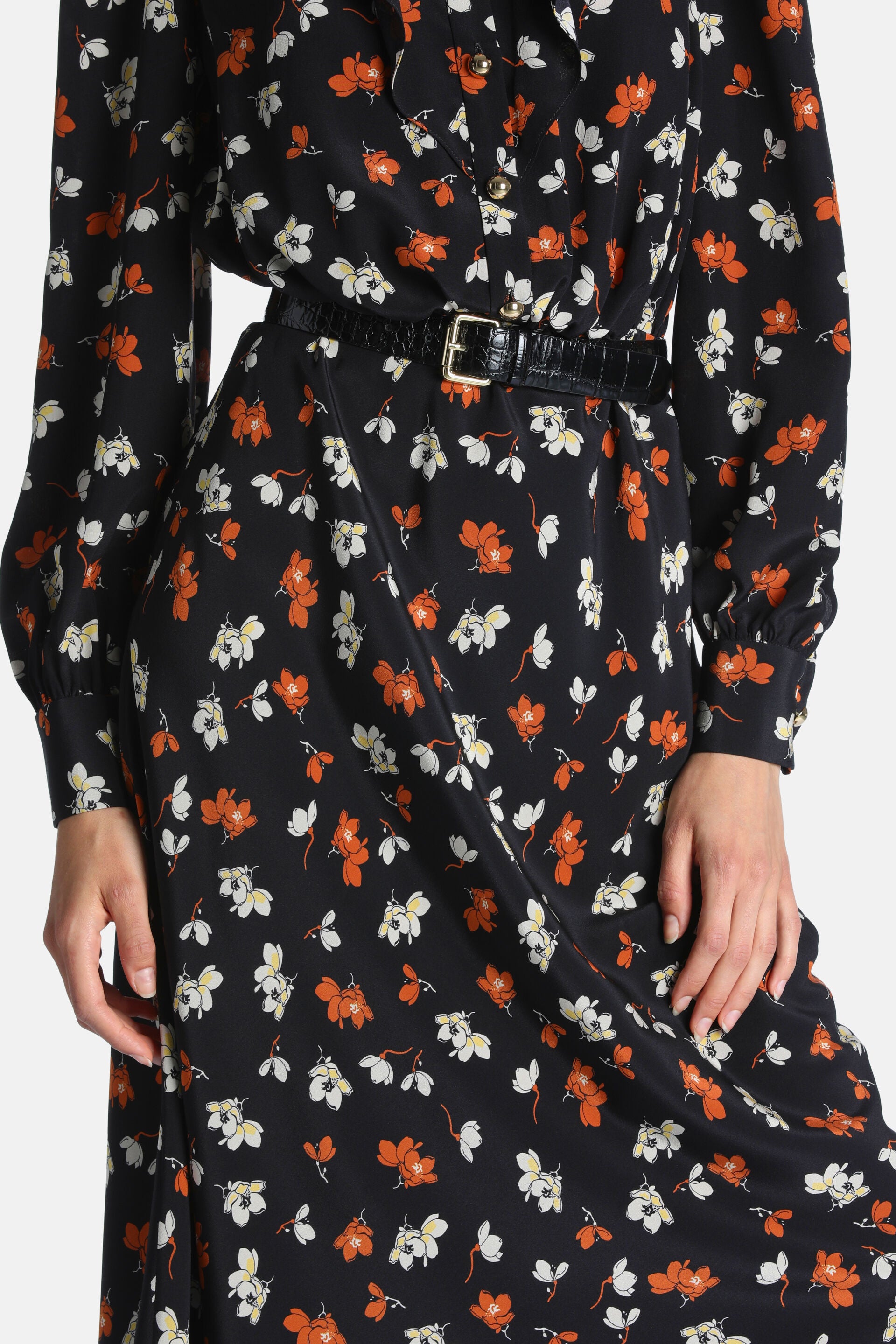 Black long-sleeved floral dress with orange and white flowers, gold-toned buttons, and a black crocodile-textured belt with a