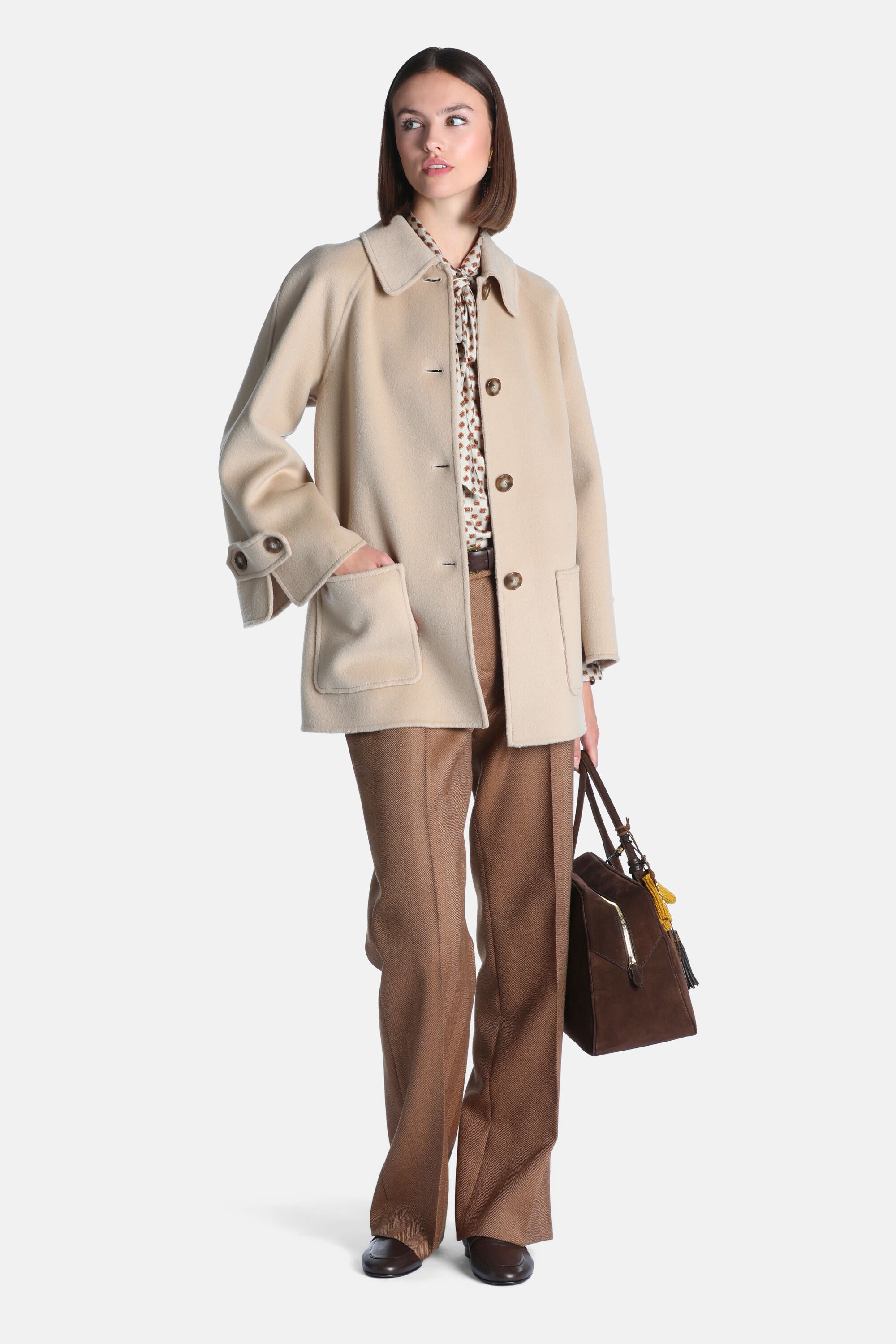 Cream single-breasted coat with a classic collar, three brown buttons, two patch pockets, and cuffs with brown buttons.