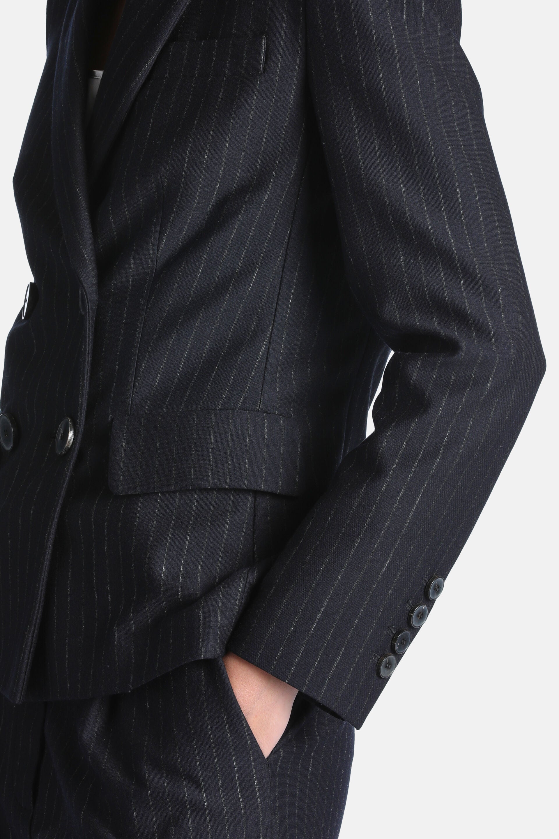 Dark blue pinstripe double-breasted blazer with notched lapels, two front buttons, a flap pocket, and four cuff buttons.