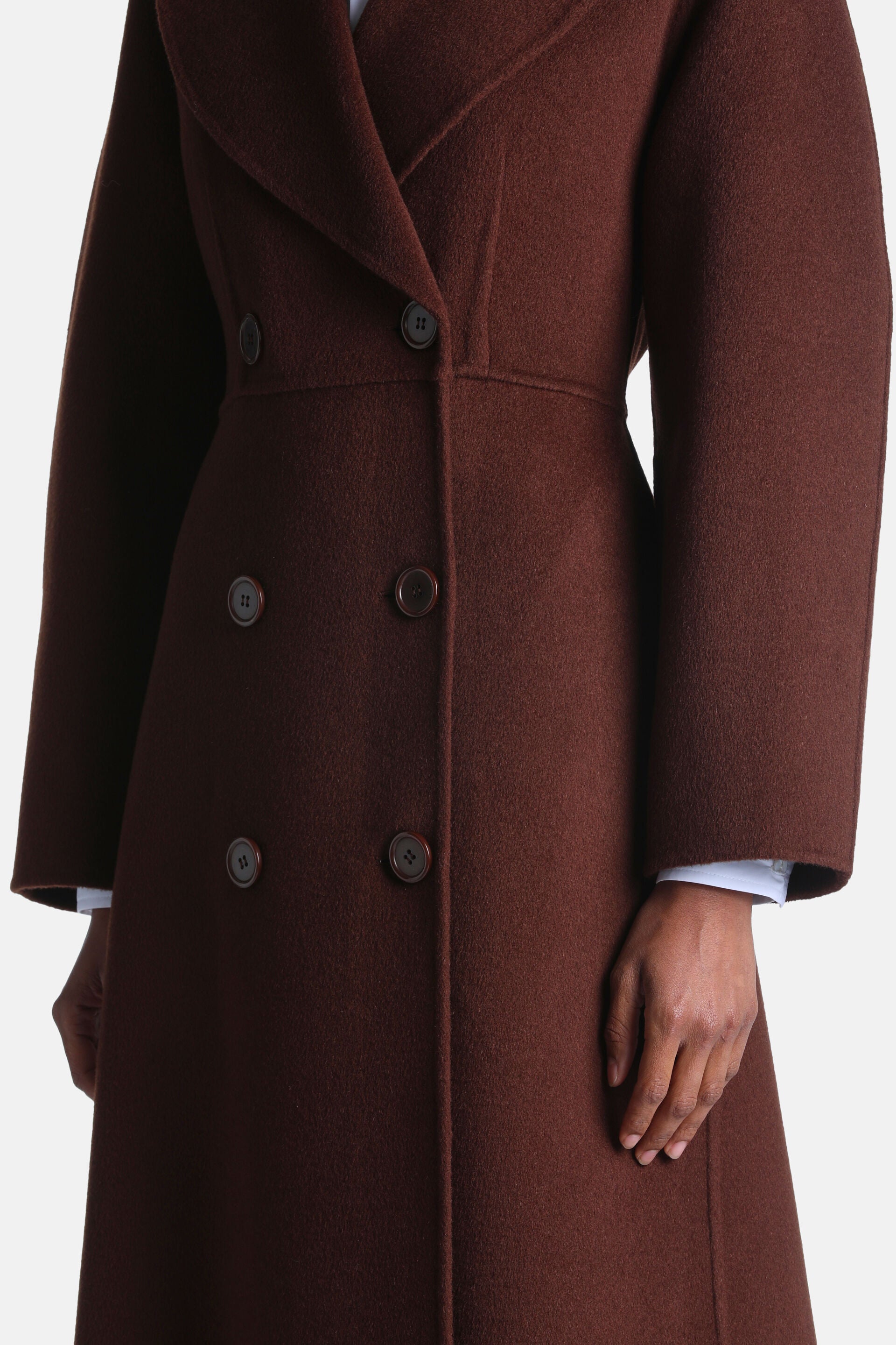 Brown double-breasted coat with wide lapels, a fitted waist, and dark brown buttons.