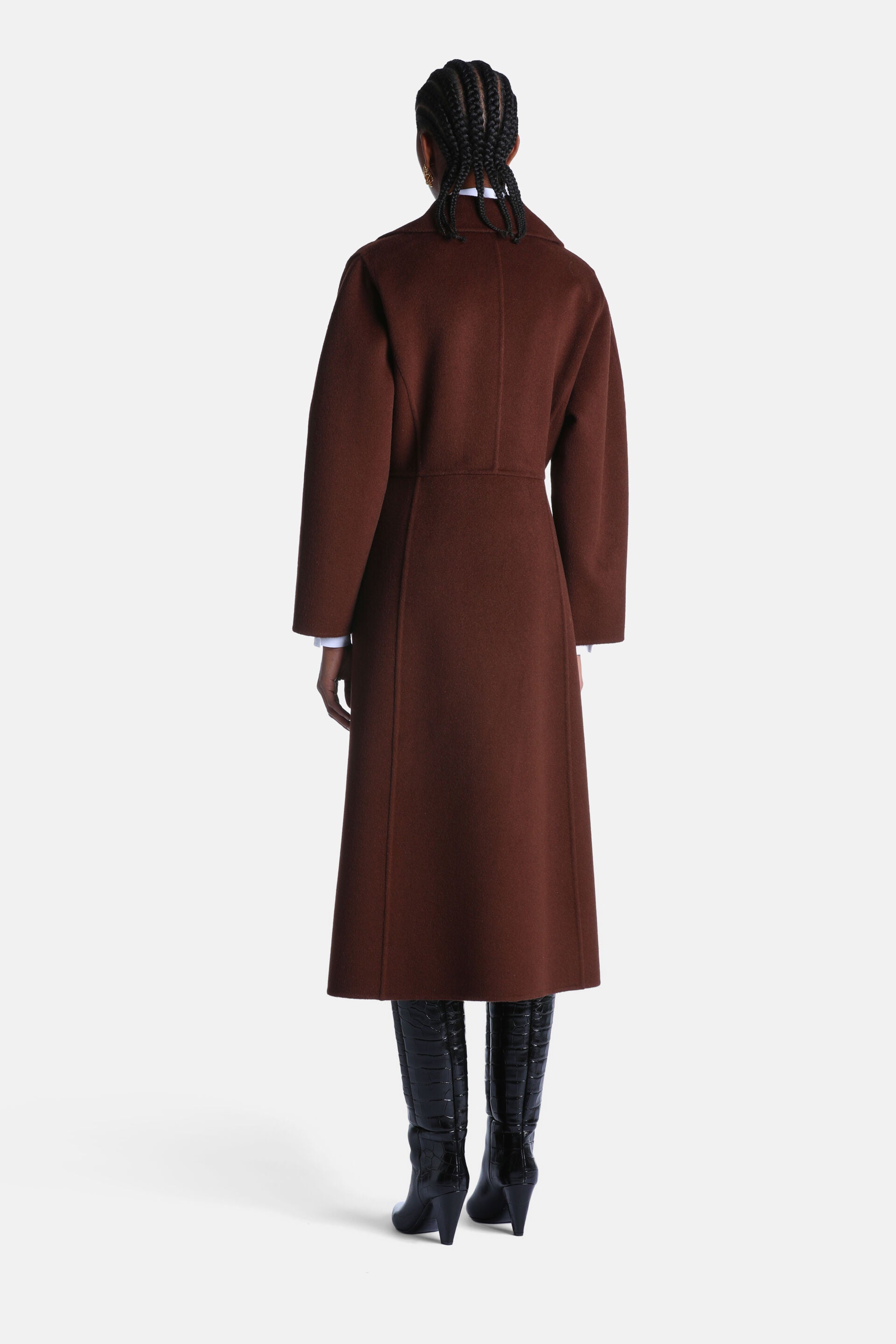 Brown long coat with a smooth texture, featuring a small collar, wide long sleeves, a defined waistline, and a clean back wit