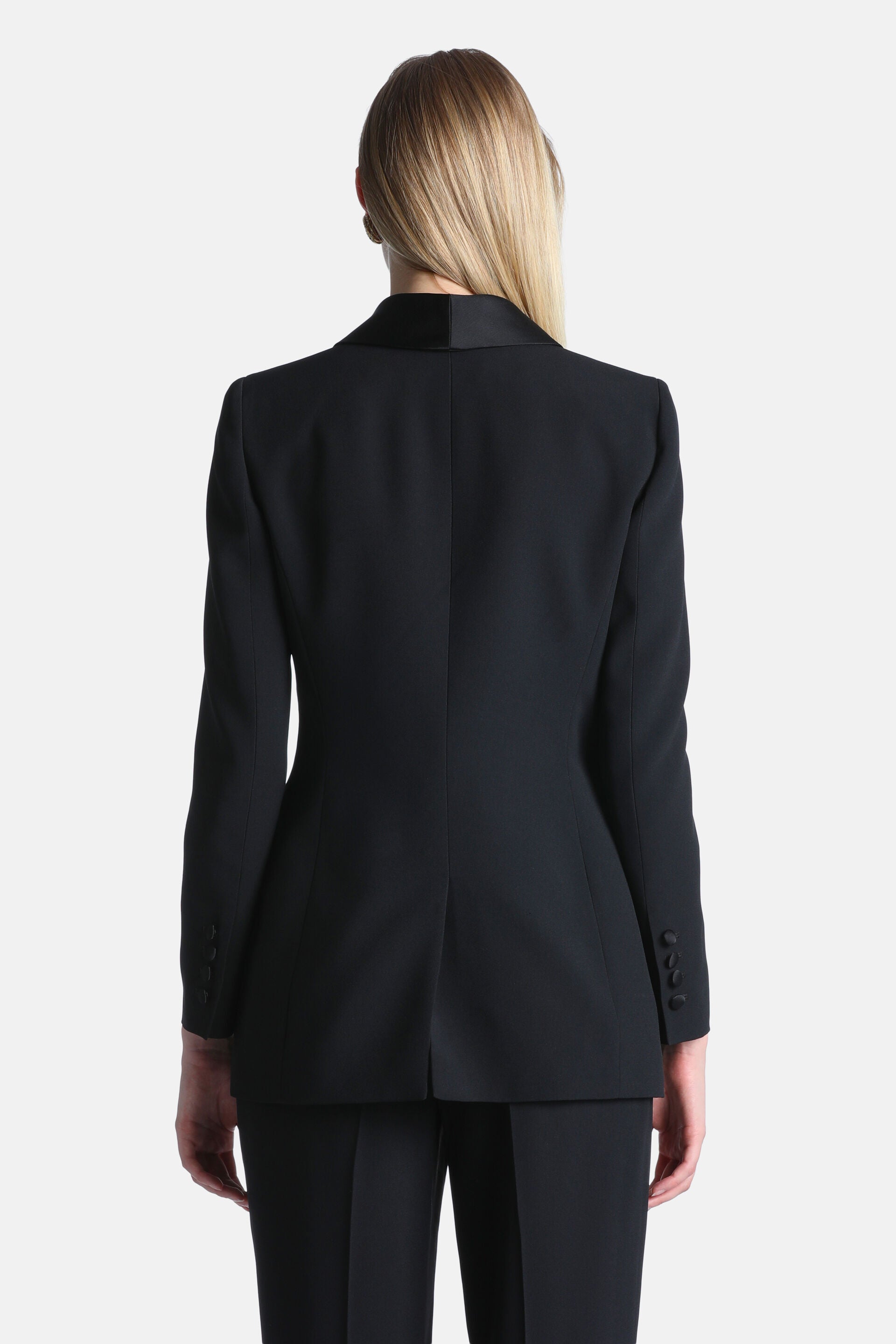 Black women's blazer with a satin-like collar, tailored back, long sleeves with four cuff buttons, and a single back vent.