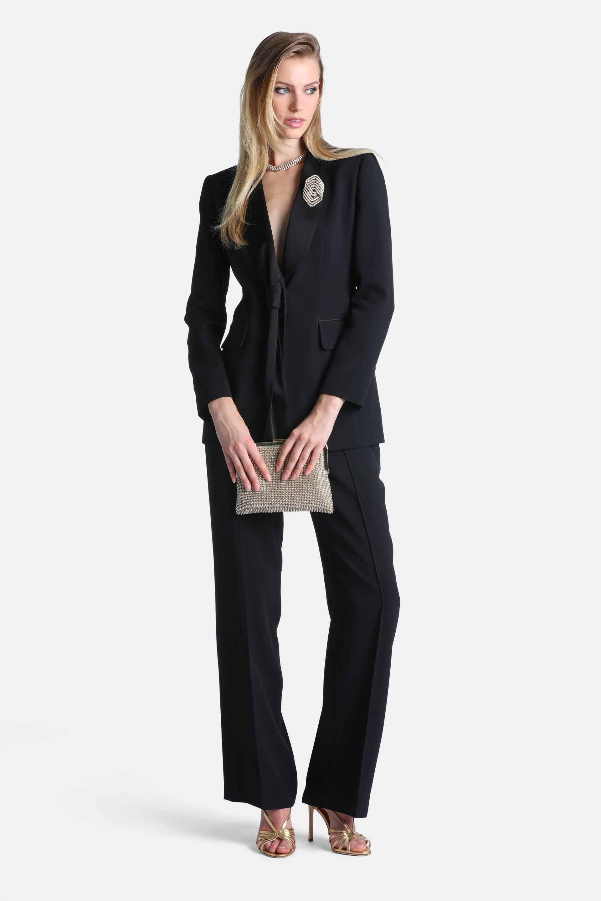 Black women's blazer with satin peak lapels, a deep V-neck, single-button closure, and two front flap pockets.
