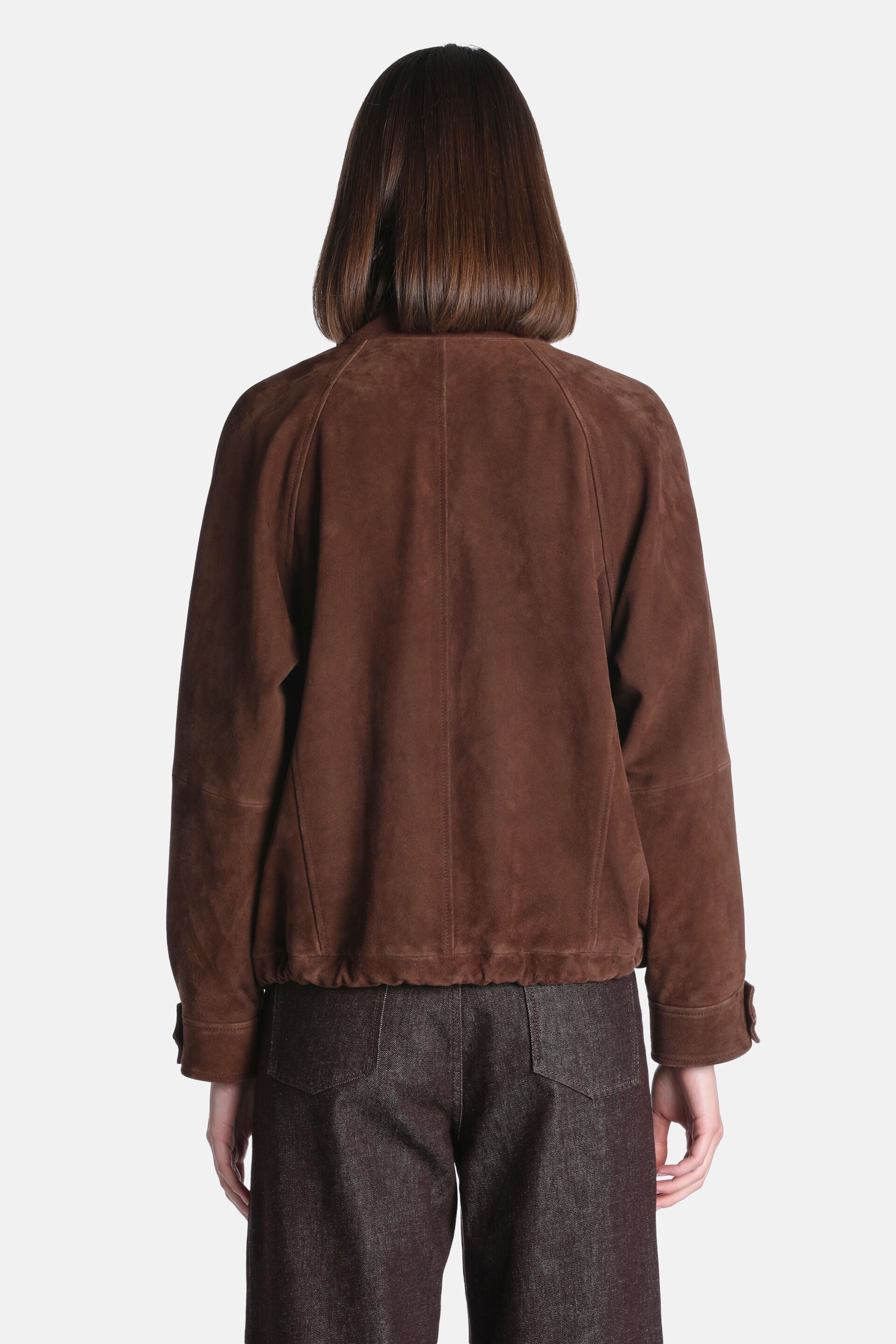 Brown suede jacket, back view, with raglan sleeves, a gathered hem, and buttoned cuffs.