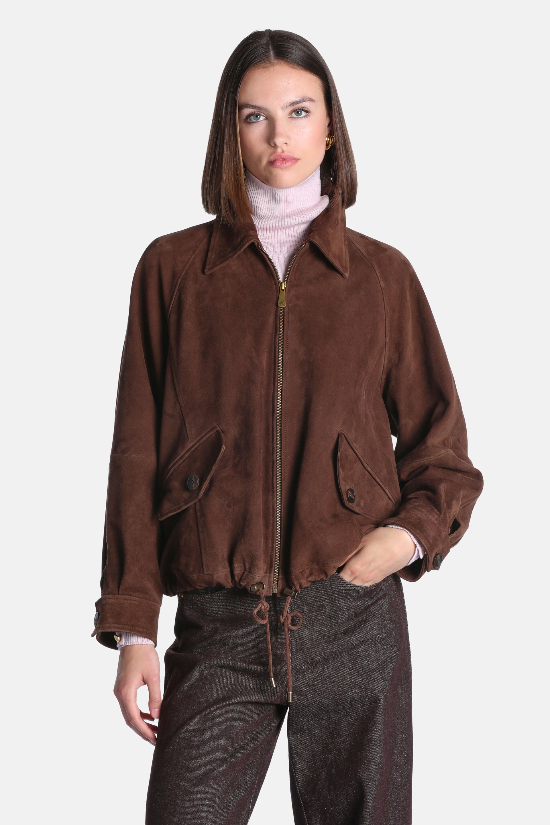 Brown suede leather bomber jacket with a pointed collar, gold-toned full zipper, two buttoned flap pockets, and a drawstring